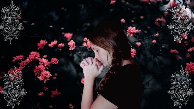 A young lady praying in the garden